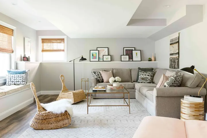 Renovated basement lounge with fireplace and built-in shelving